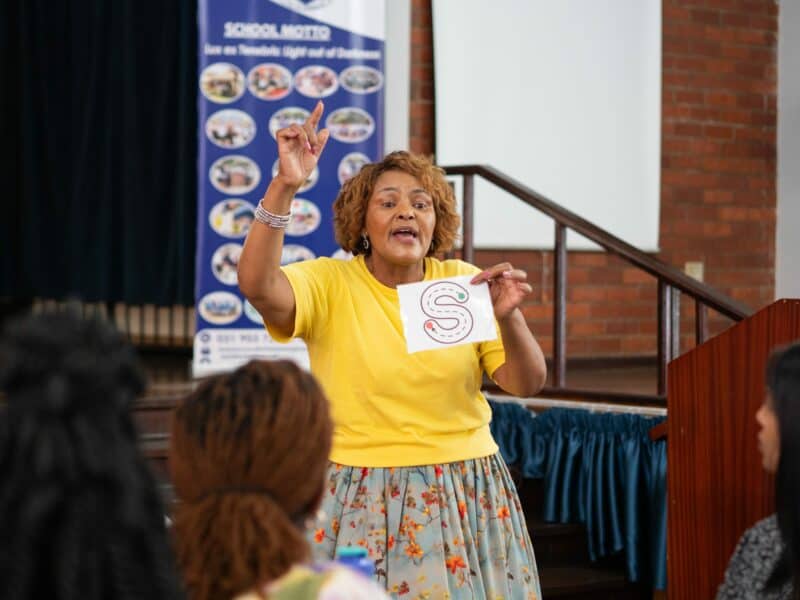 a woman teaching phonics to fellow teachers
