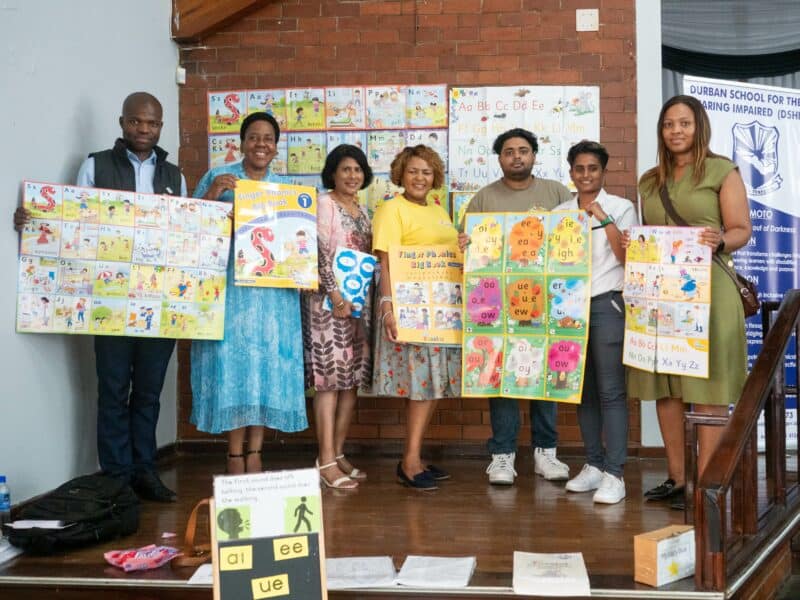 a group photo with people showing learning resources