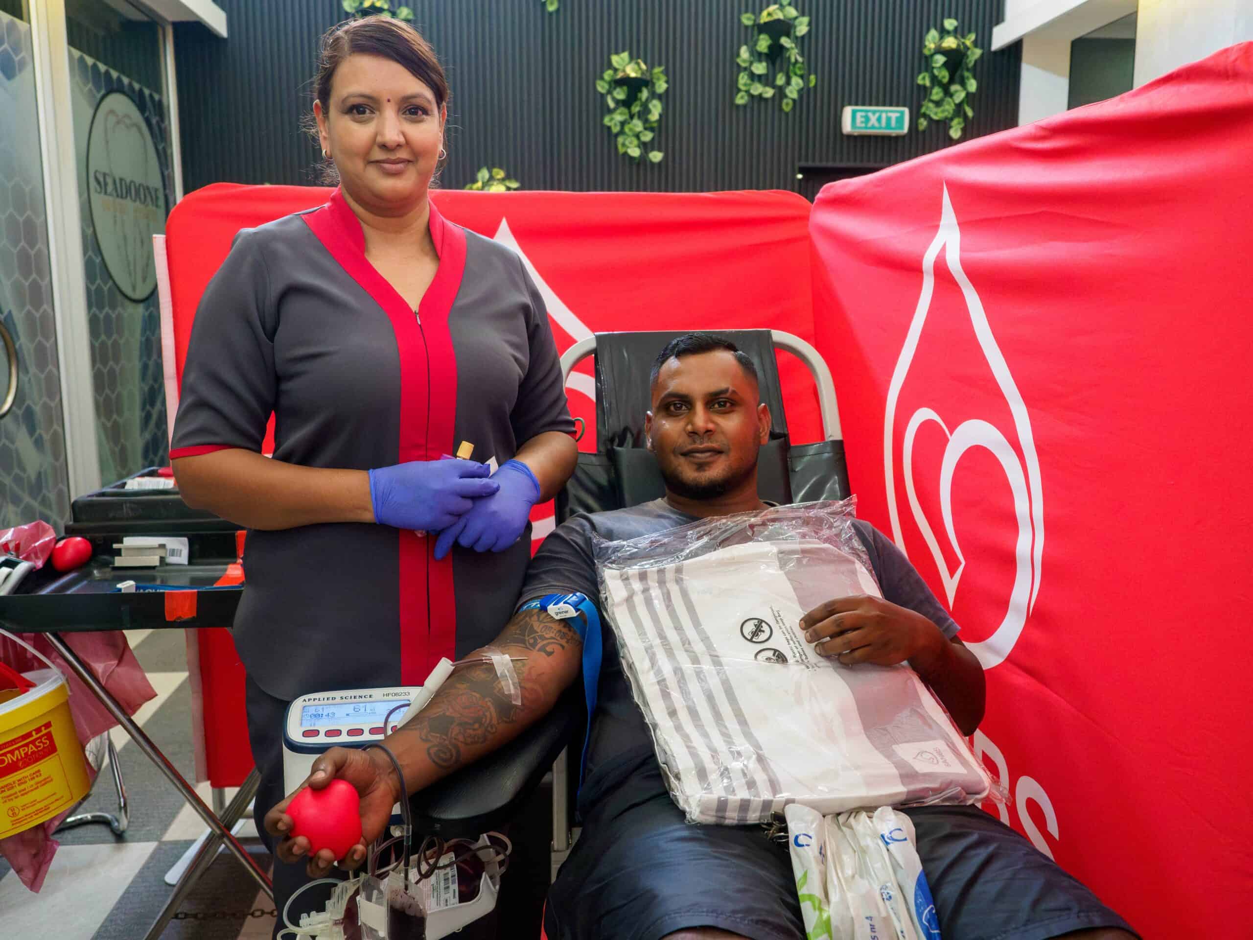 a nurse with a man donating blood