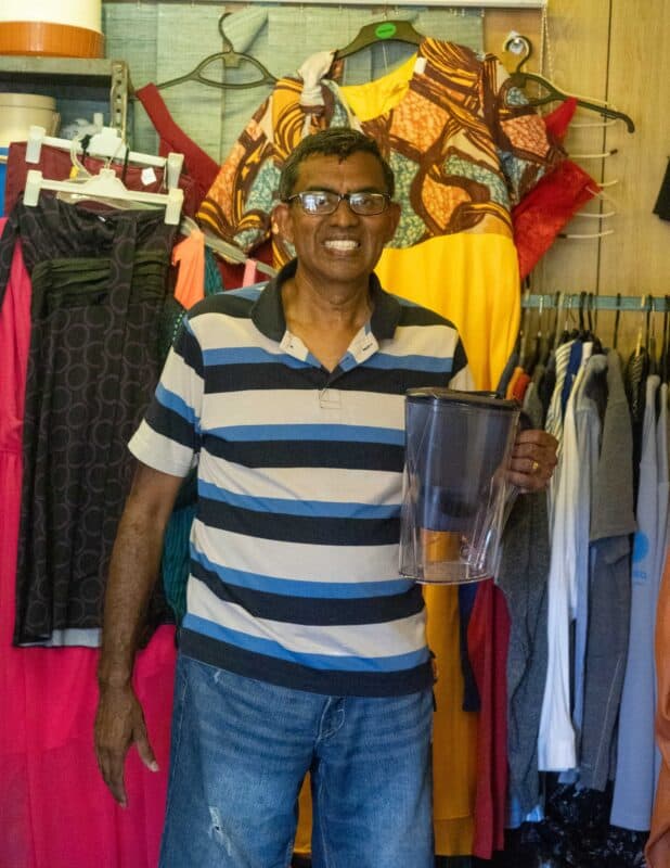 a man holding a juice jug
