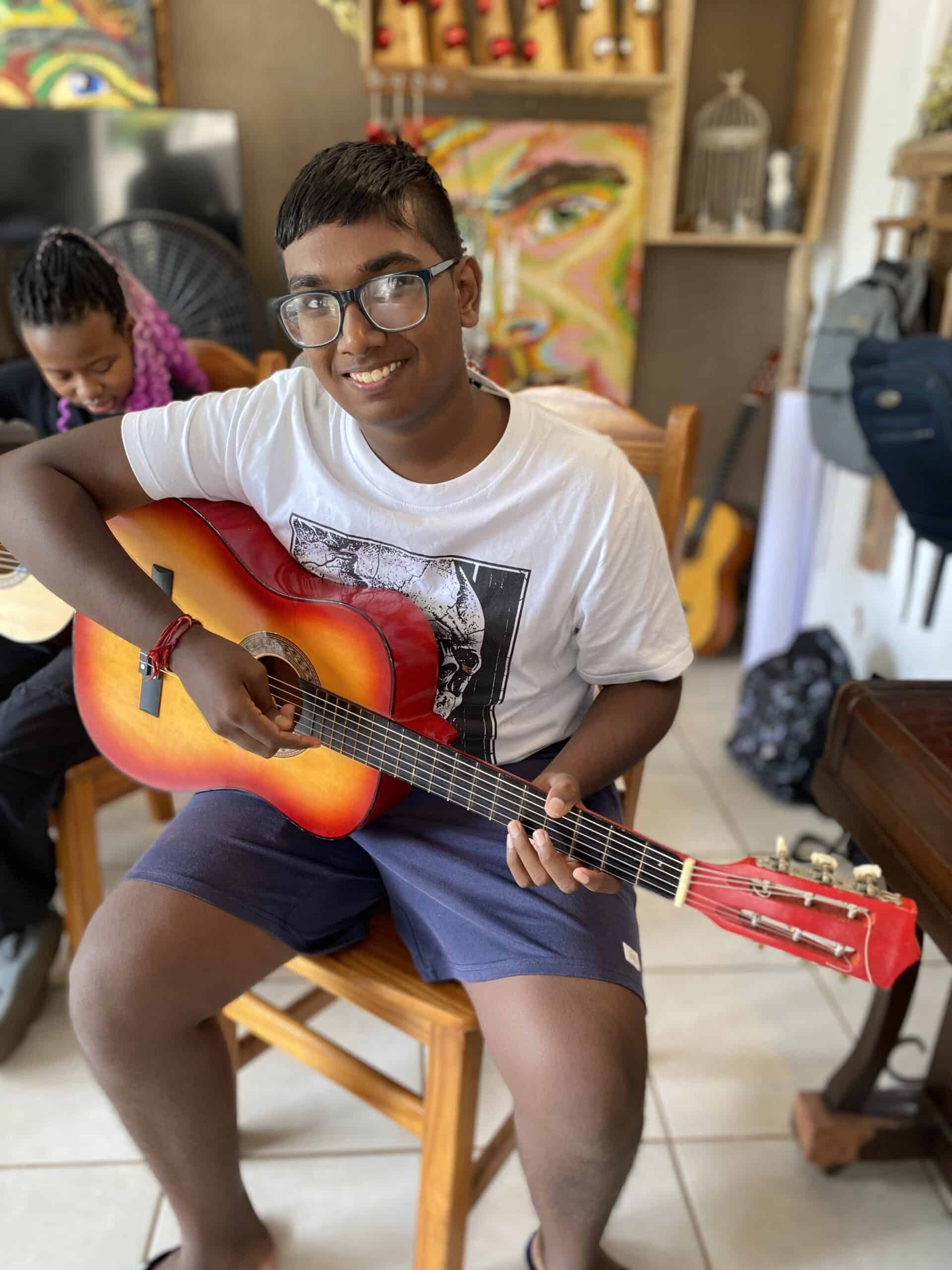 a student learning to play guitar