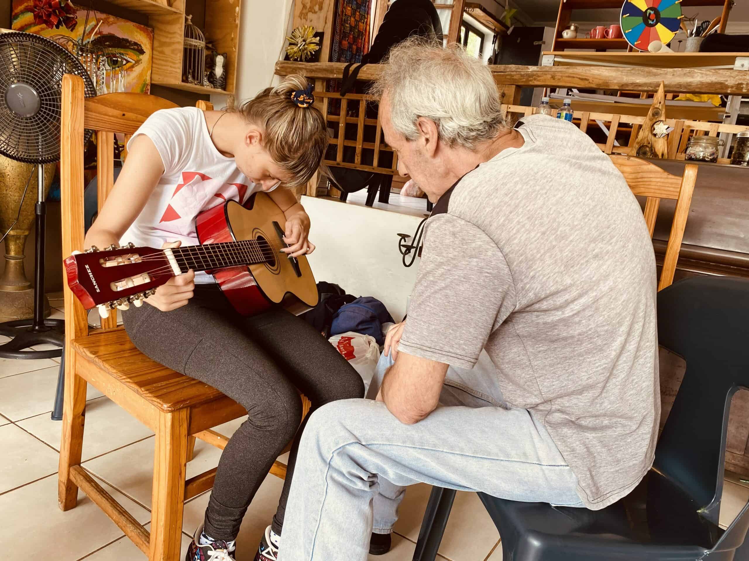 a student learning to play guitar