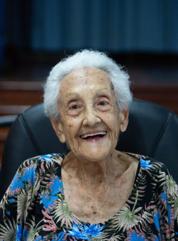 an elderly woman smiling for a portrait