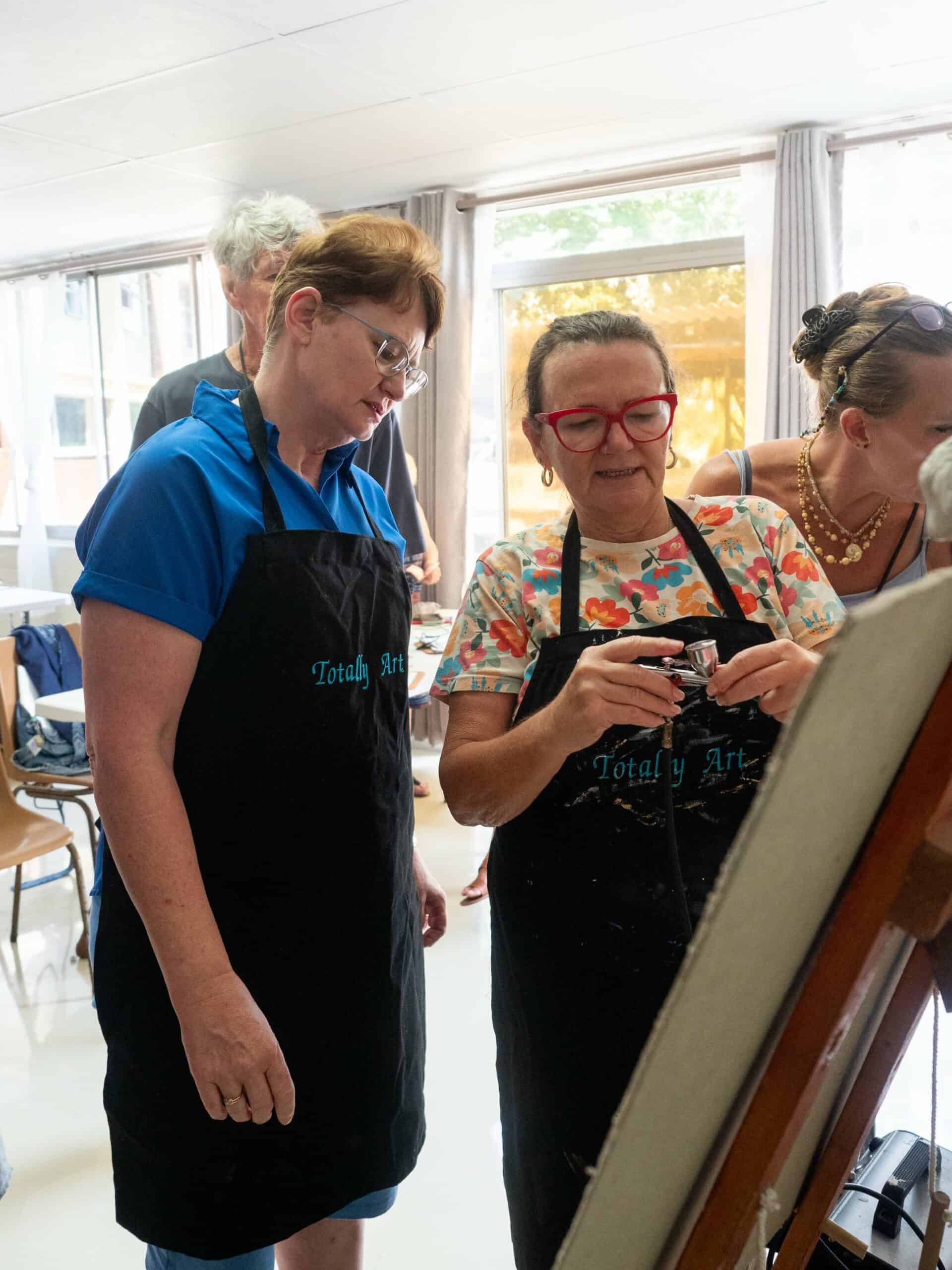 two artists working on airbrush art