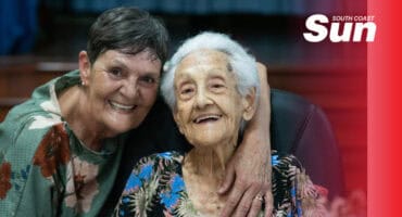 two elderly woman smiling