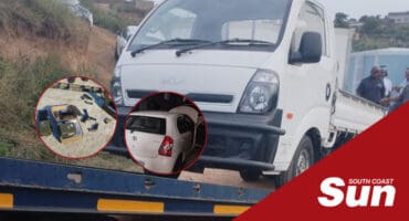 a vehicle being loaded onto a trailer. firearms inset, a stolen vehicle