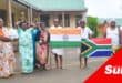 a group of people in traditional Indian attire holding indian and south african national flags