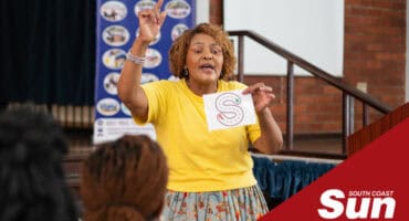 a woman teaching phonics to fellow teachers