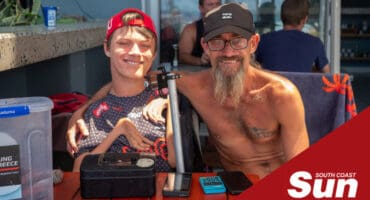 a paraplegic son and his father sitting at a beach restaurant