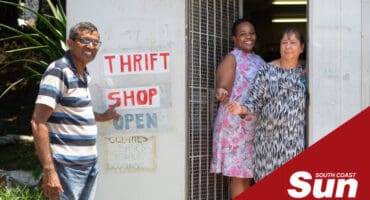 a man and two women at a thrift shop