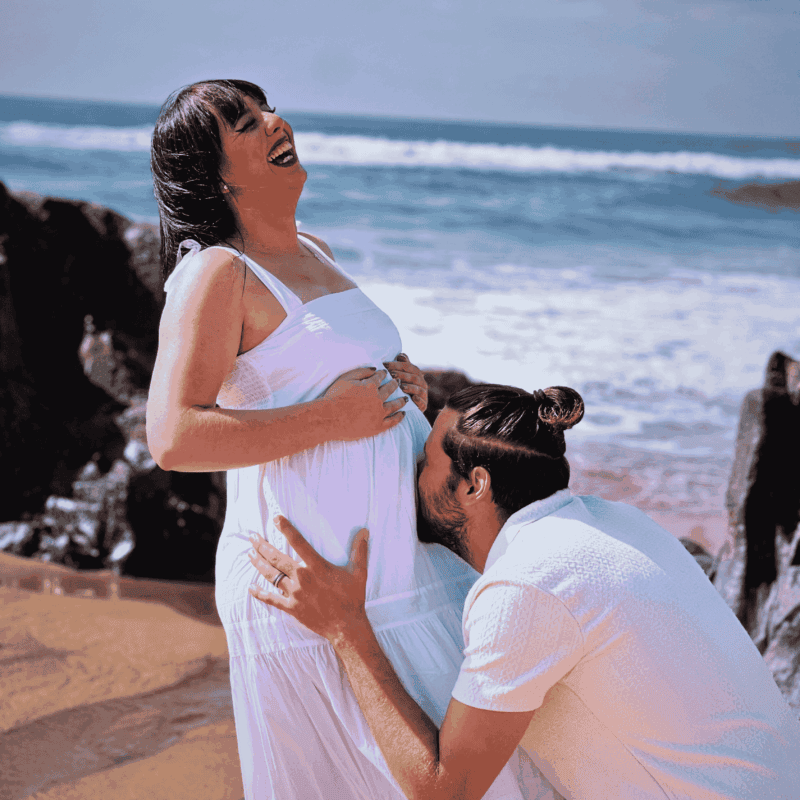 a pregnant couple on the beach