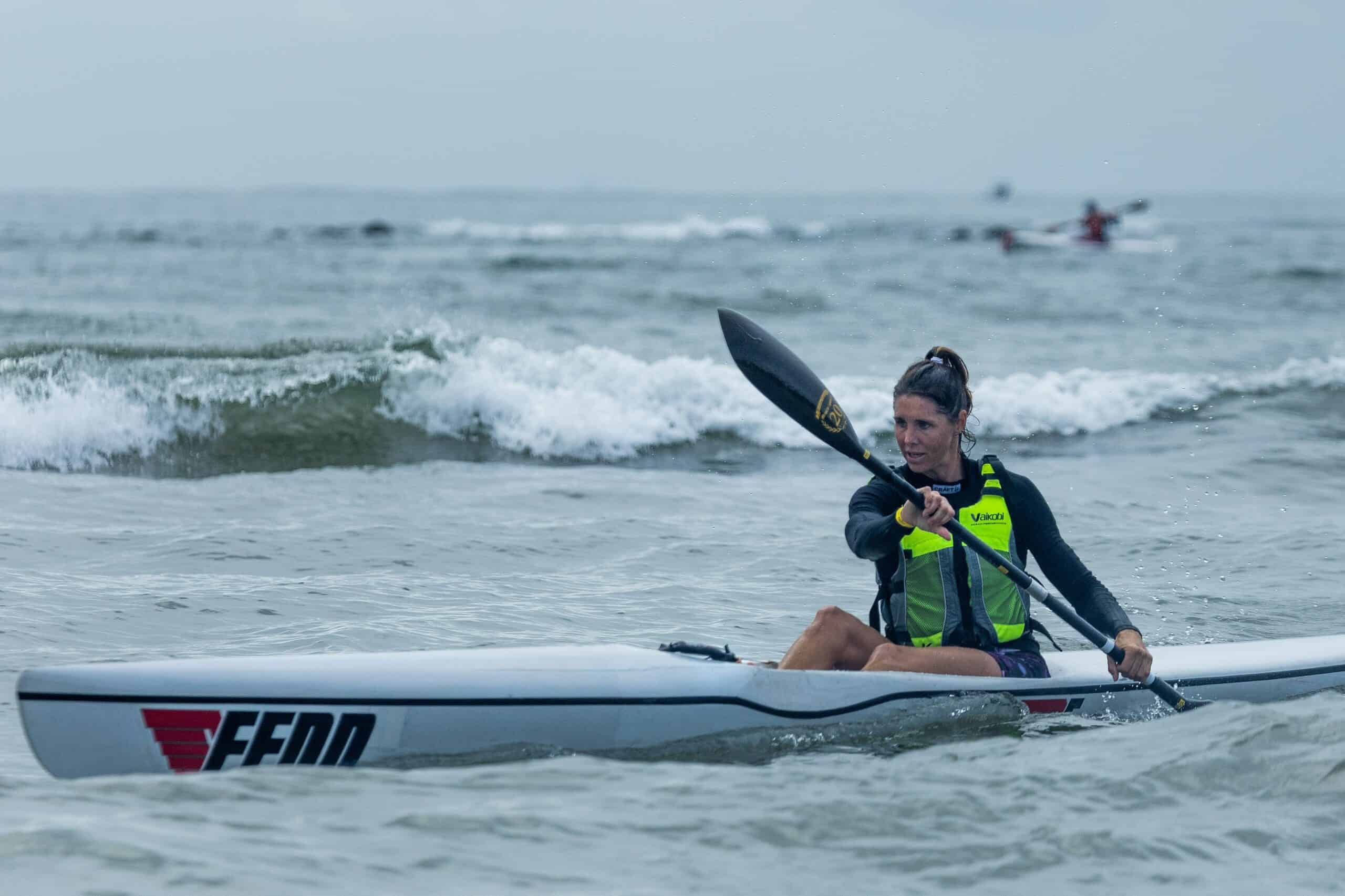 a woman kayaking in the ocean