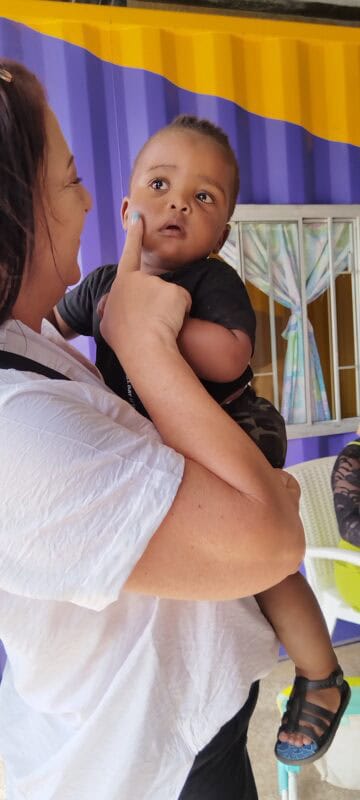 a woman holding a baby