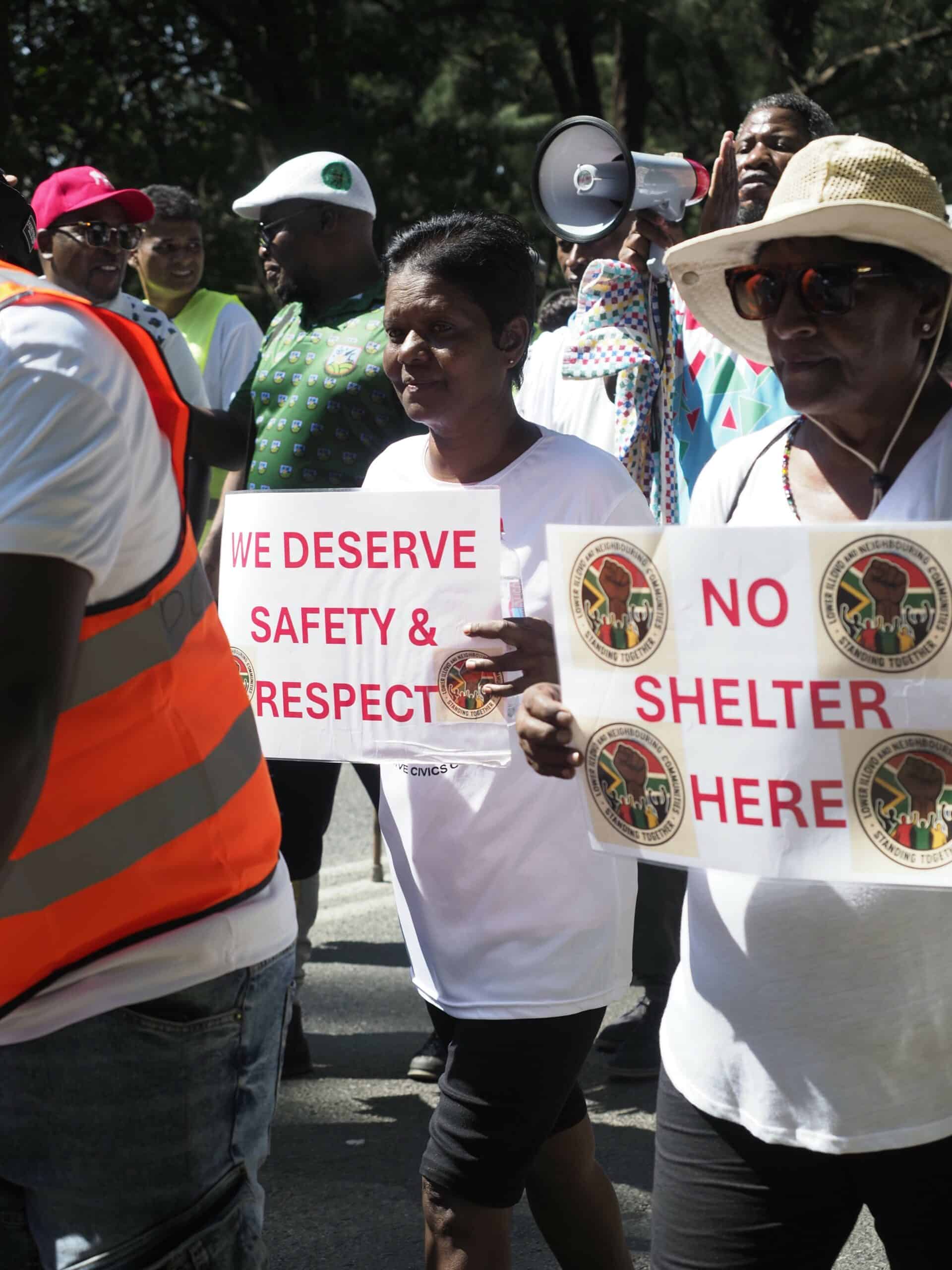 protestors marching and holding up placards