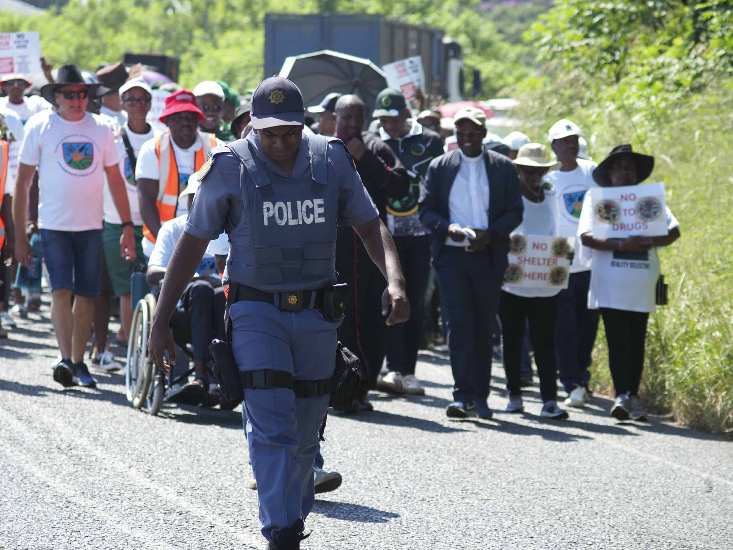 protestors marching and holding up placards
