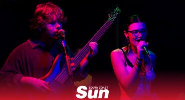 a bassist and a singer performing on stage