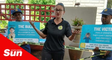 a woman delivering a talk, animated expressions. police holding up anti-bullying signs