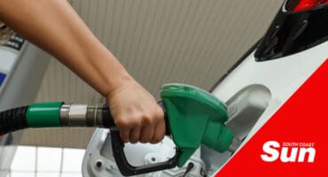 a person filling fuel in their car