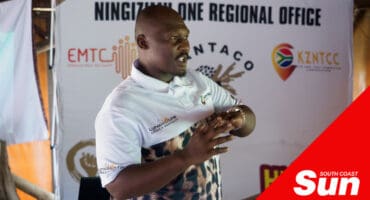 a man speaking in front to an audience