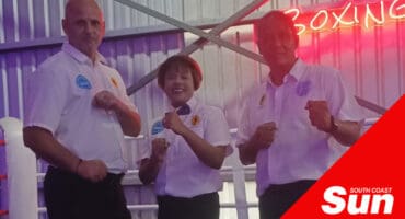 a group of kickboxing referees pose in a fighting stance