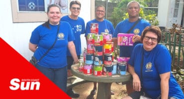 a group photo with donated pet food cans