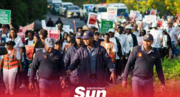 police leading a large group of protestors on a march