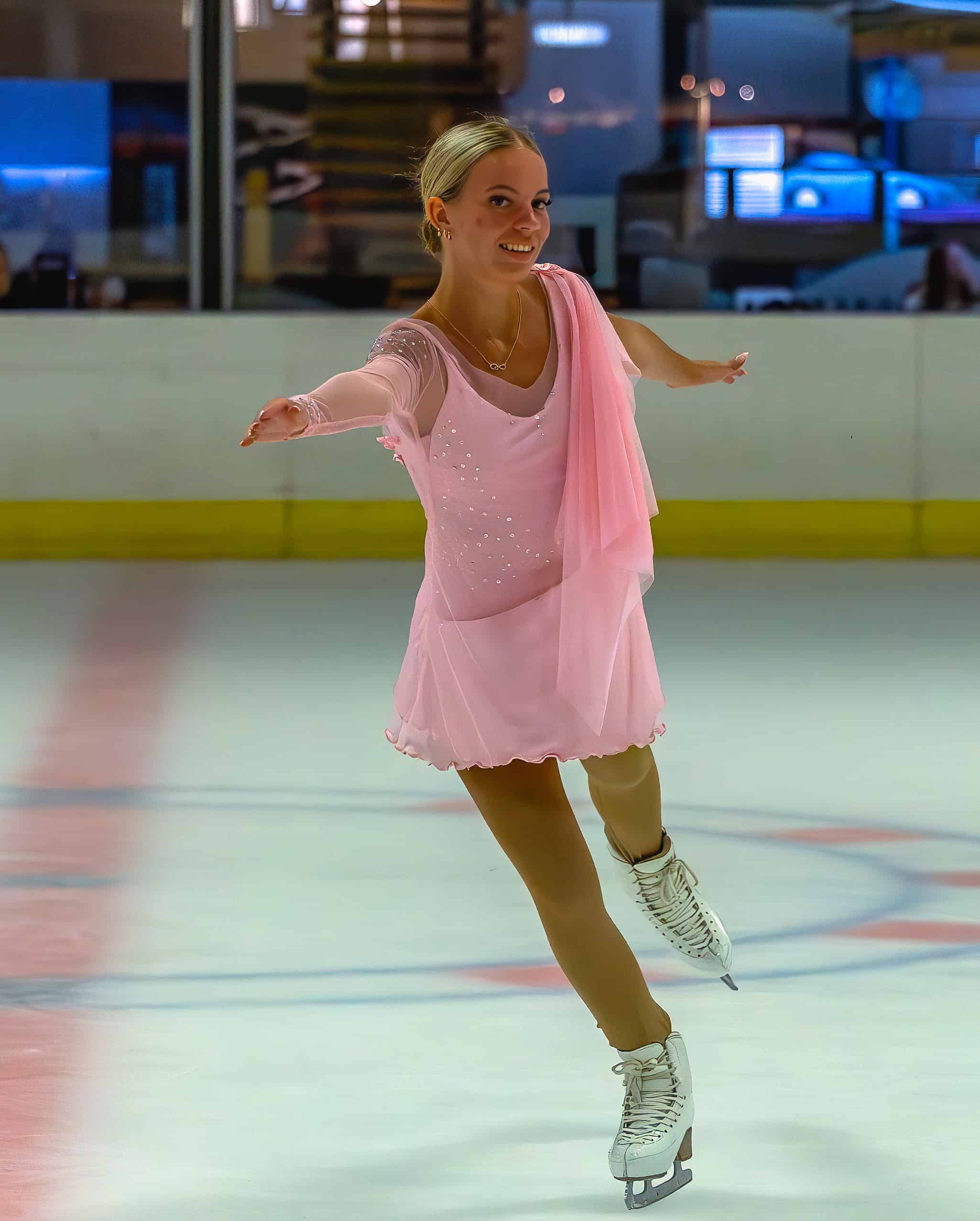 a figure skating gliding along in an ice rink