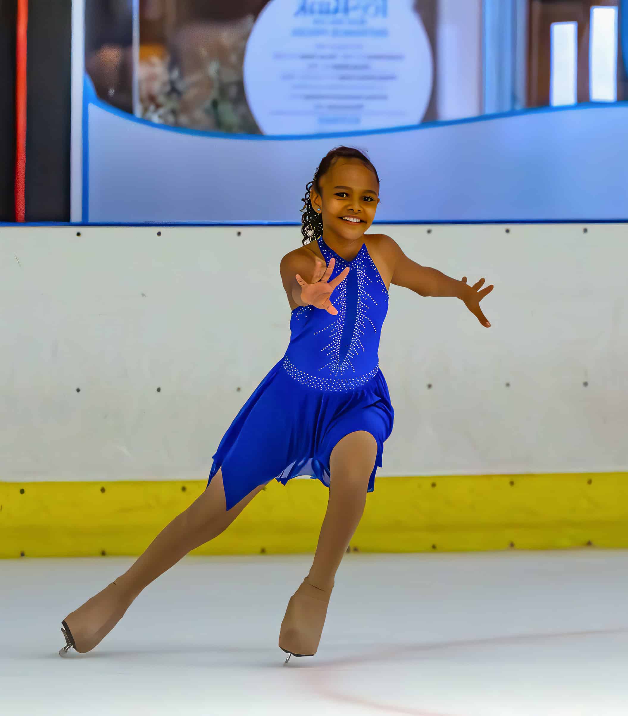 a figure skating gliding along in an ice rink