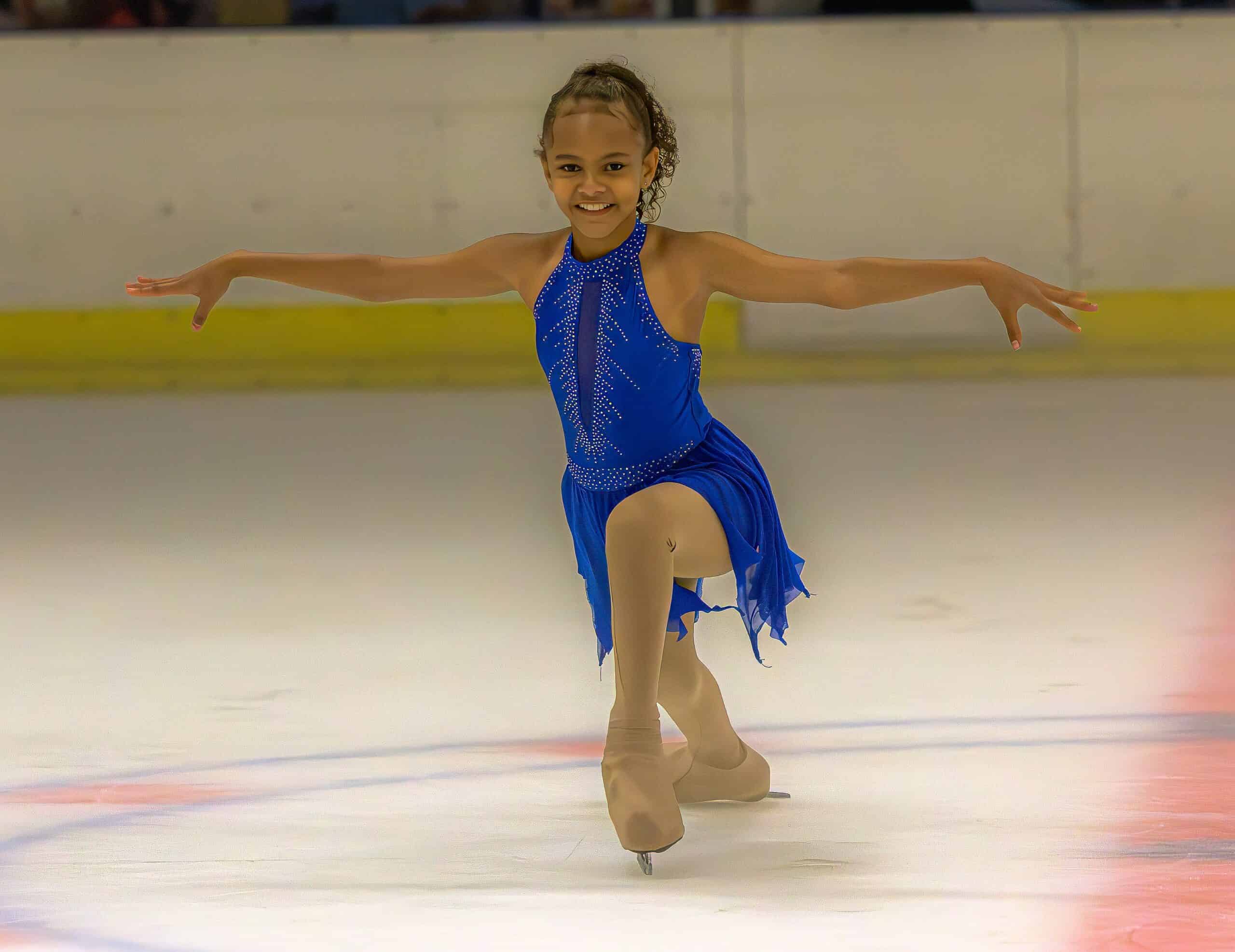 a figure skating gliding along in an ice rink