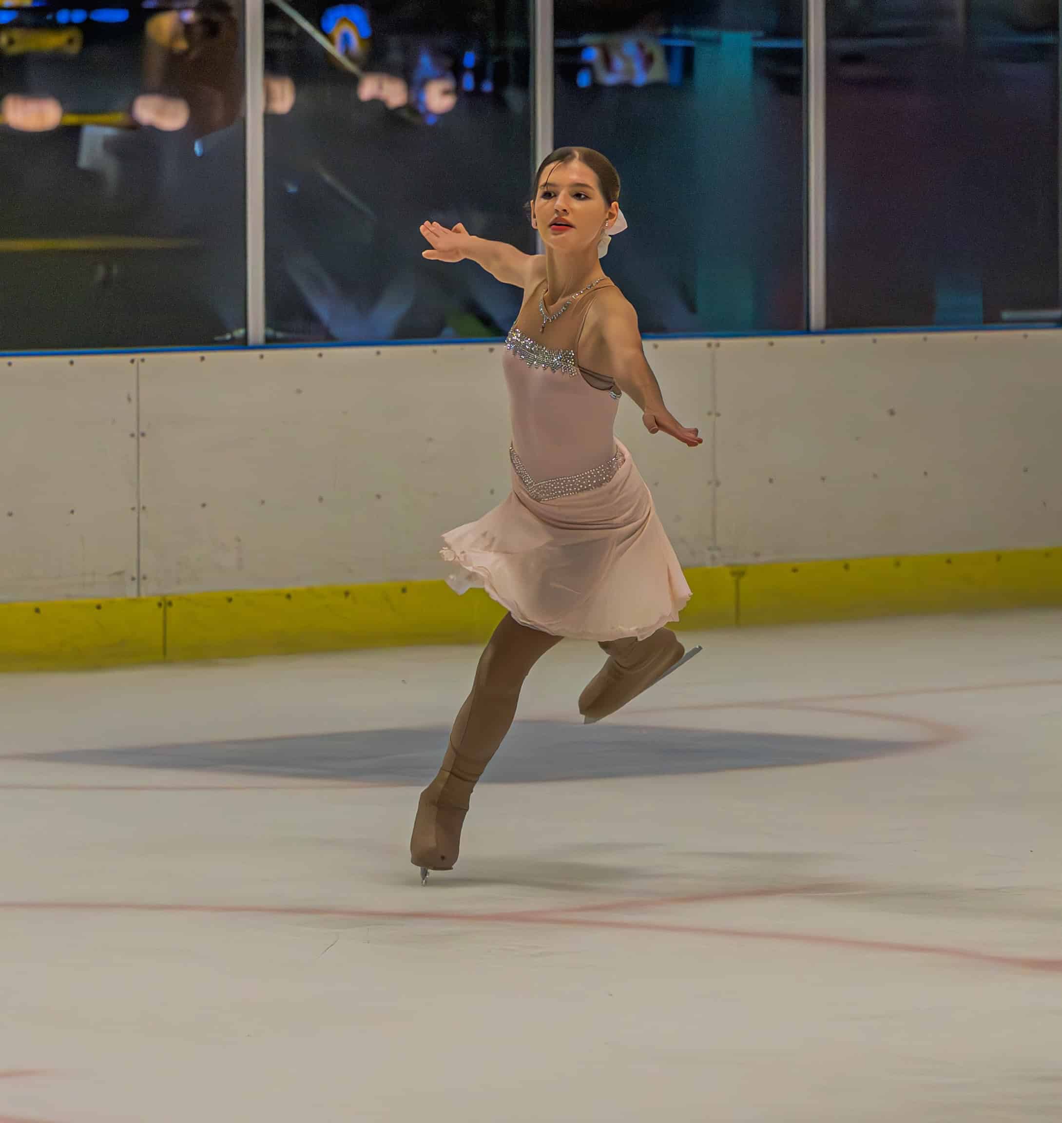 a figure skating gliding along in an ice rink
