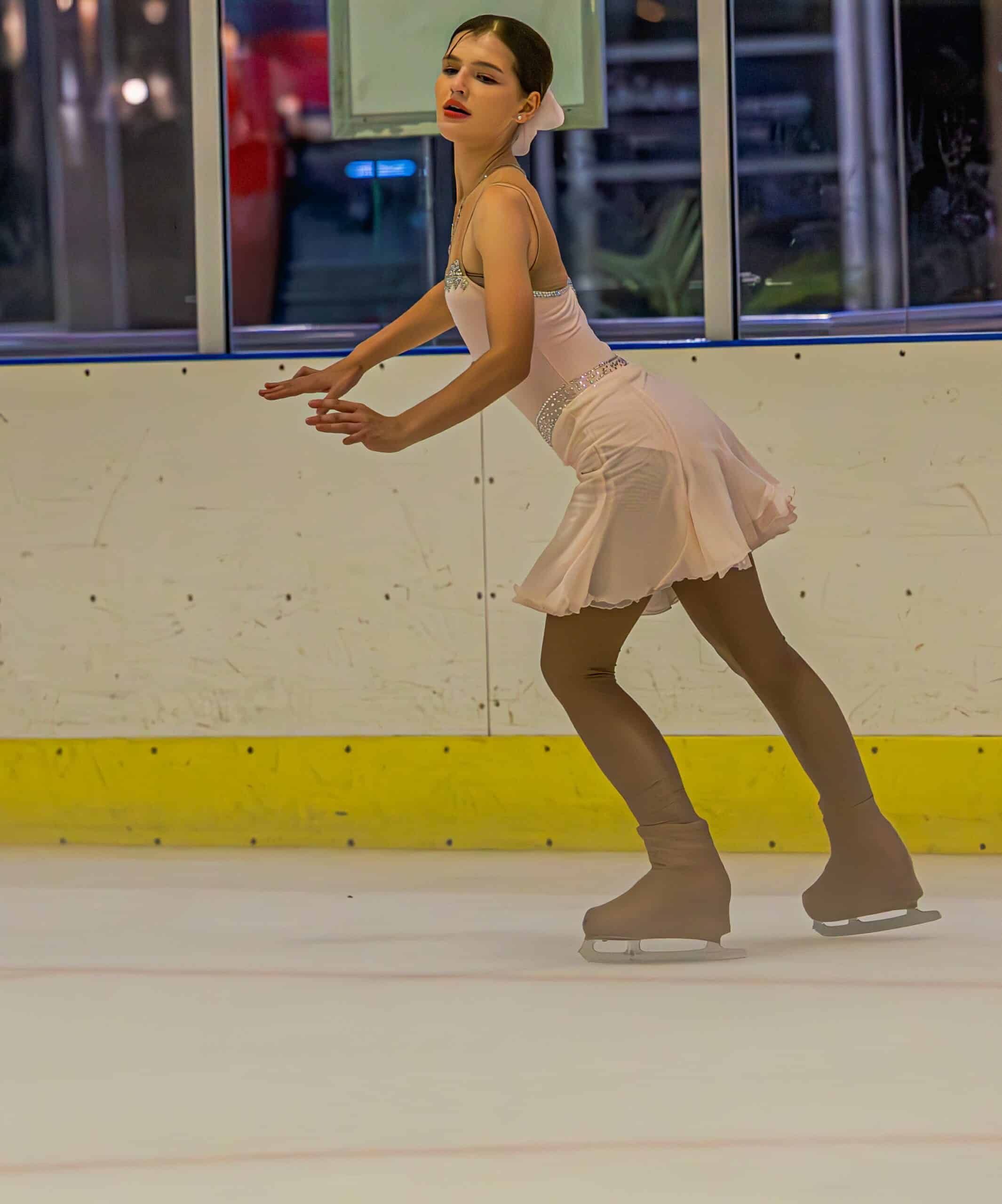 a figure skating gliding along in an ice rink