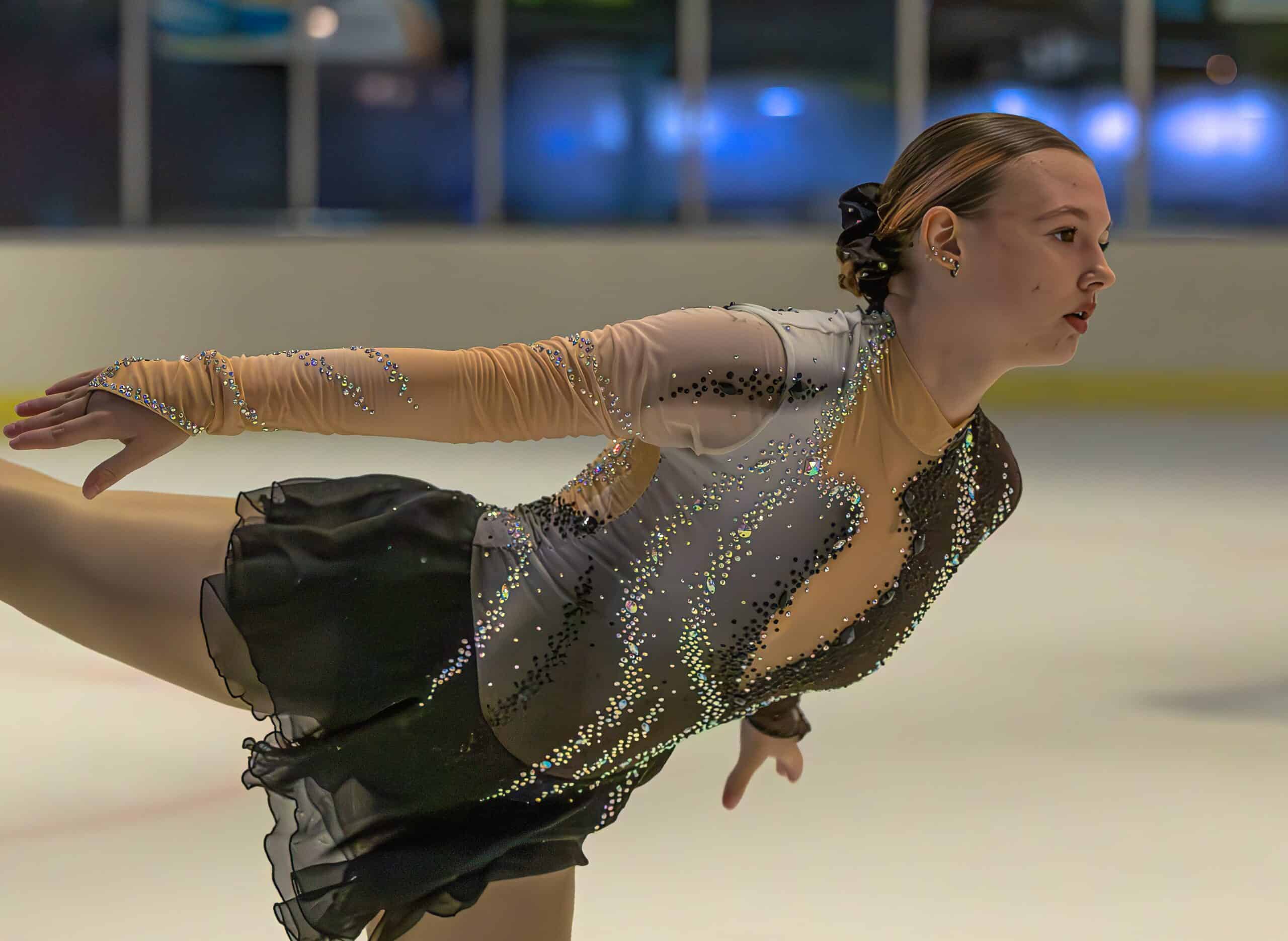 a figure skating gliding along in an ice rink