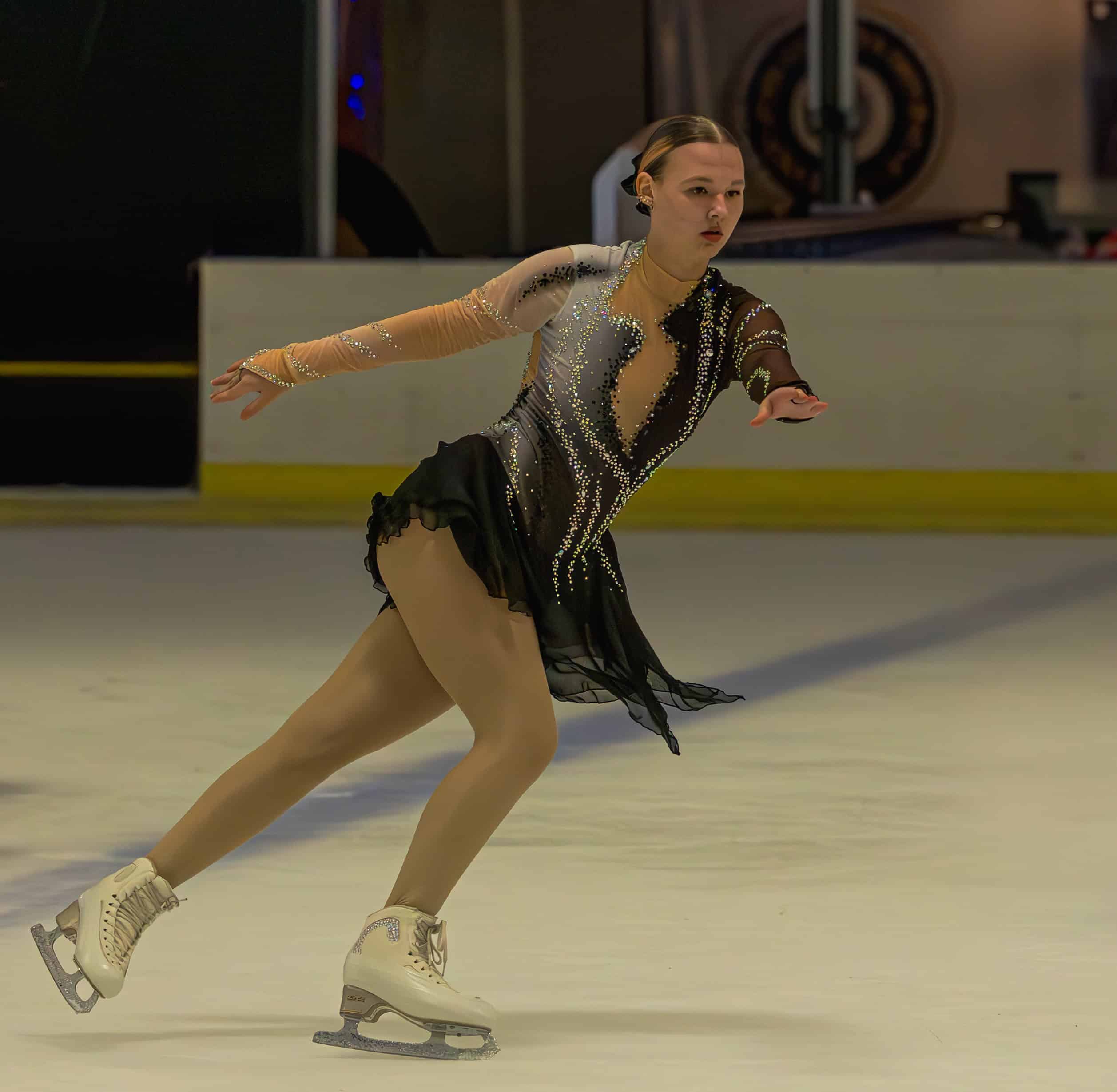 a figure skating gliding along in an ice rink