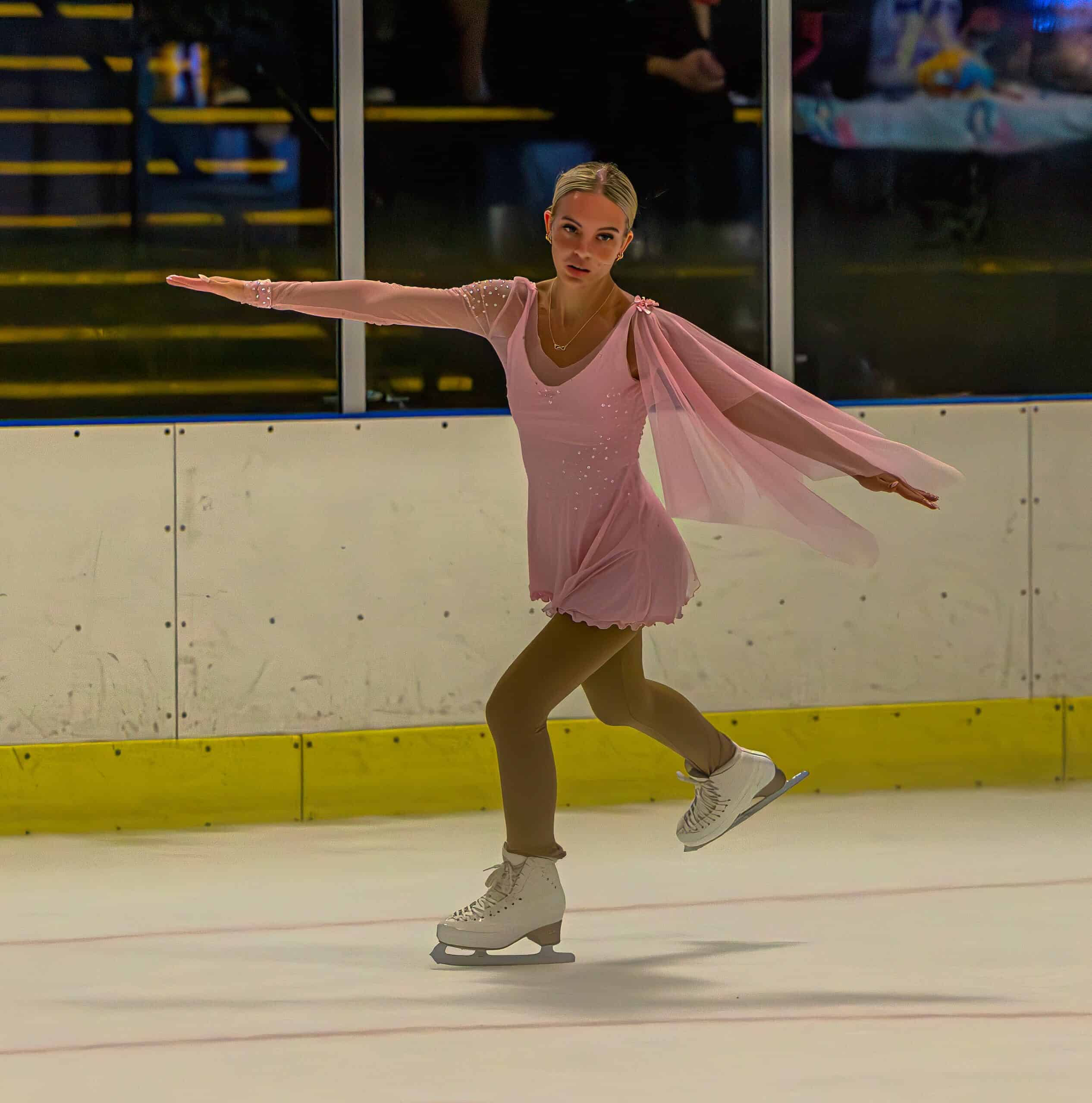 a figure skating gliding along in an ice rink