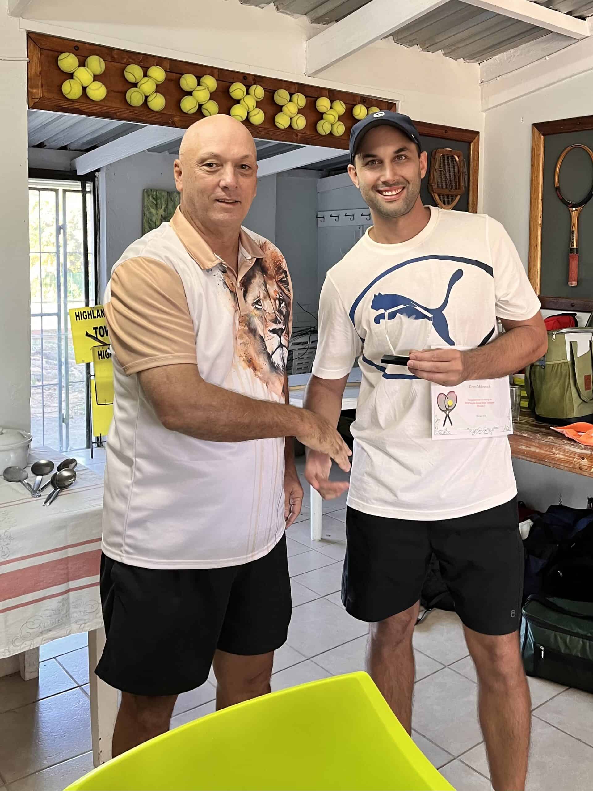 a man handing a tennis player a trophy and certificate