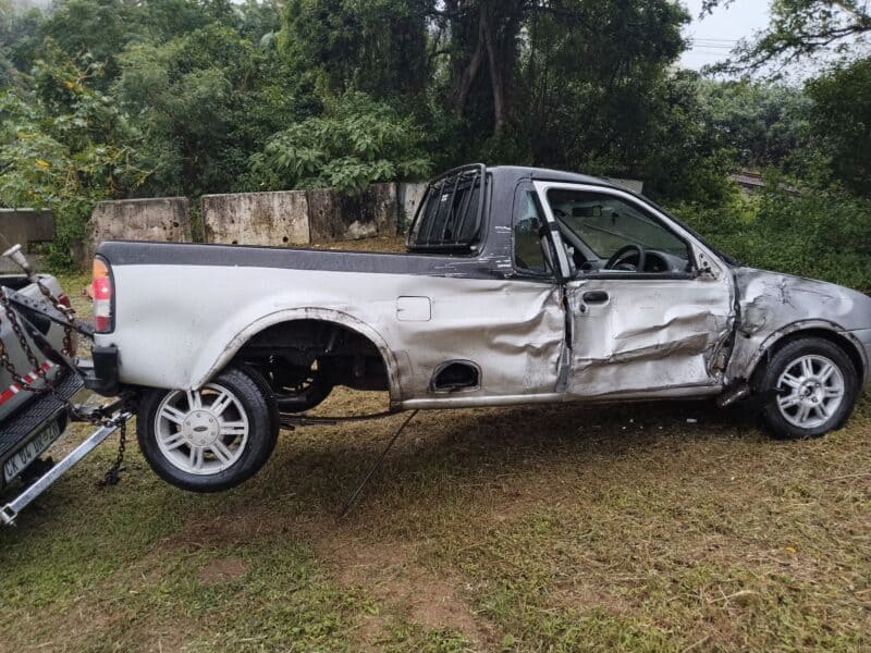 A totalled vehicle being towed away