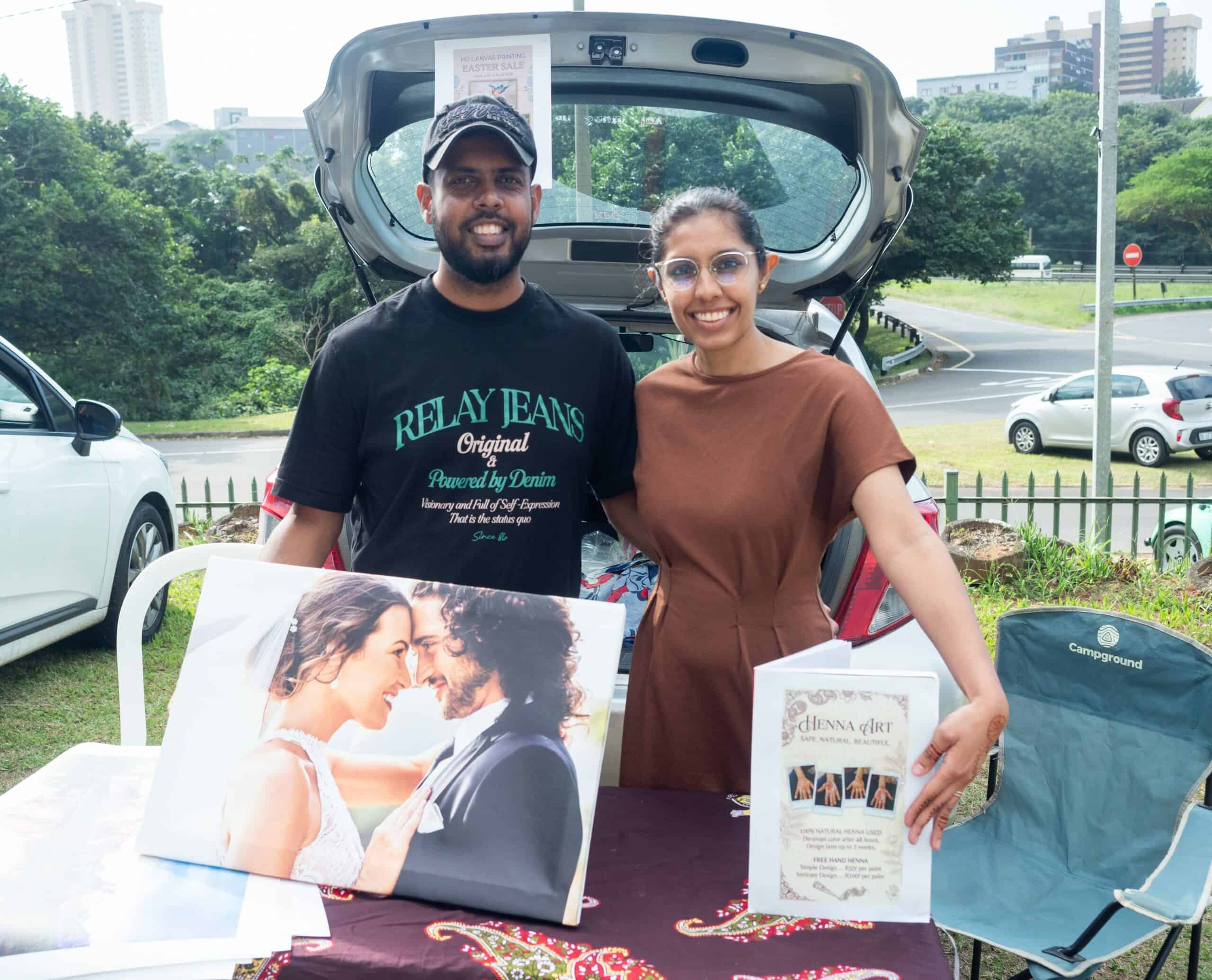 a man and a woman with mehndi and wedding photos
