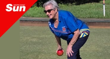 a woman bowling on greens