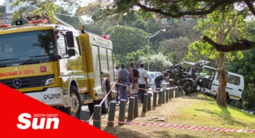 an accident scene with emergency services and a severely damaged taxi