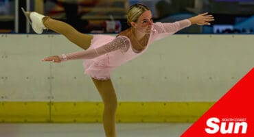 a figure skating gliding along in an ice rink