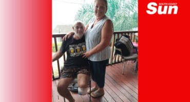 a couple, the man is disabled, missing a leg, the woman is standing, holding him