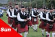 a pipe band performing during a highland gathering