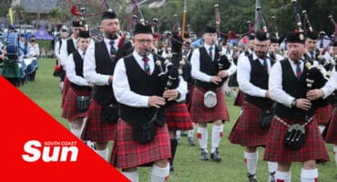 a pipe band performing during a highland gathering