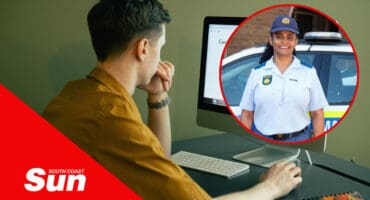 a man working at a computer. a woman in police uniform.