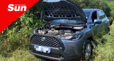 a vehicle on a patch of grass with the bonnet opened