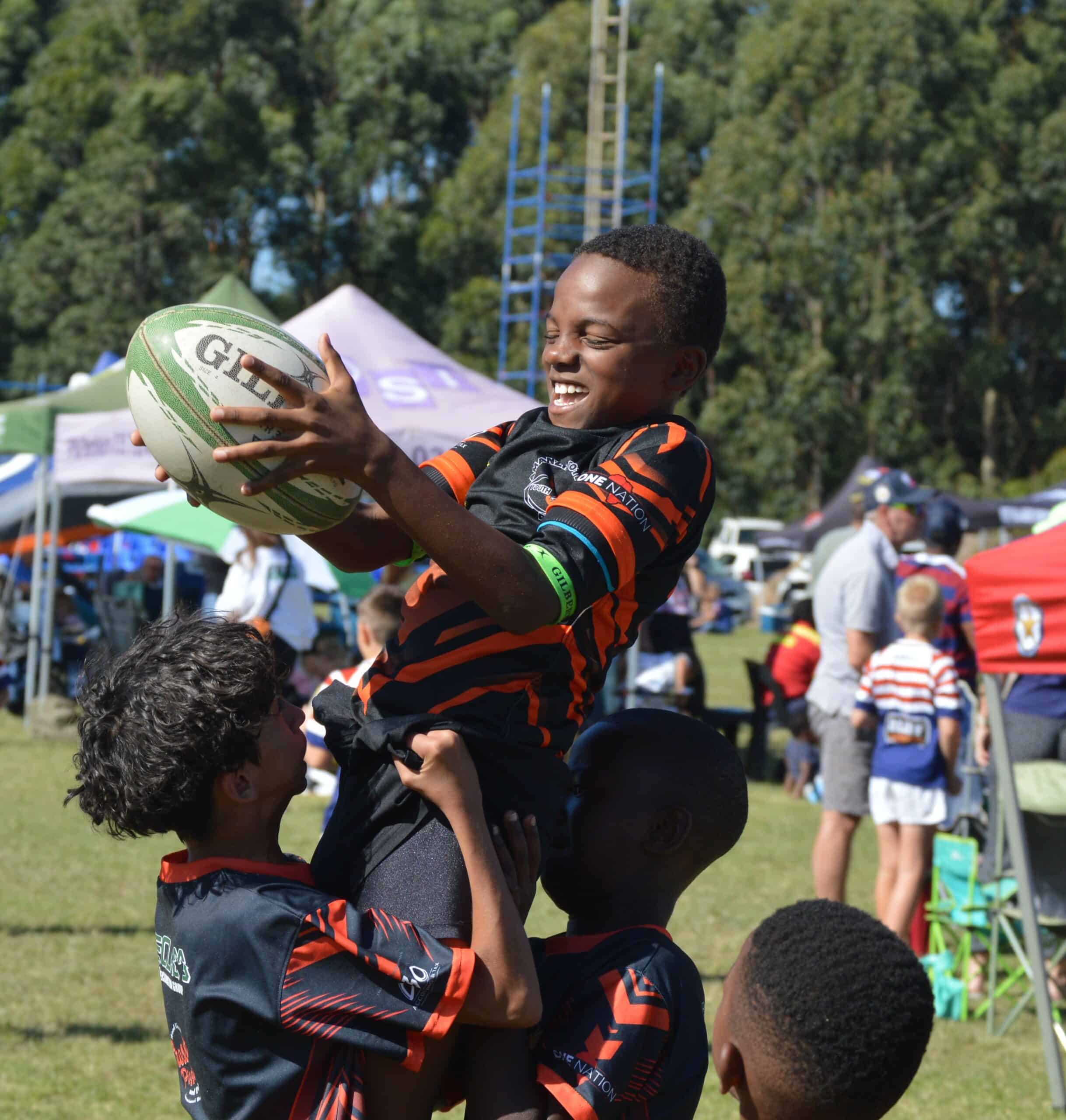 a rugby player is hoisted up for a throw in