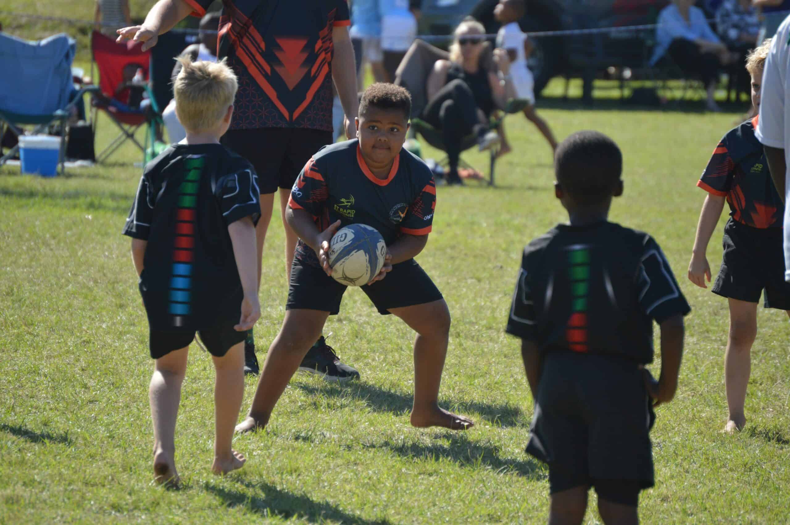 a rugby player is holding the ball