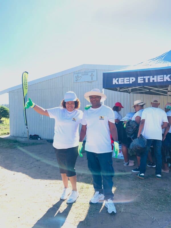 two people with hats and rubber gloves