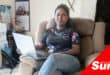 a woman sitting on a couch with a laptop
