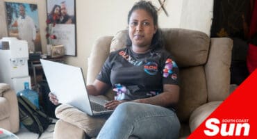 a woman sitting on a couch with a laptop